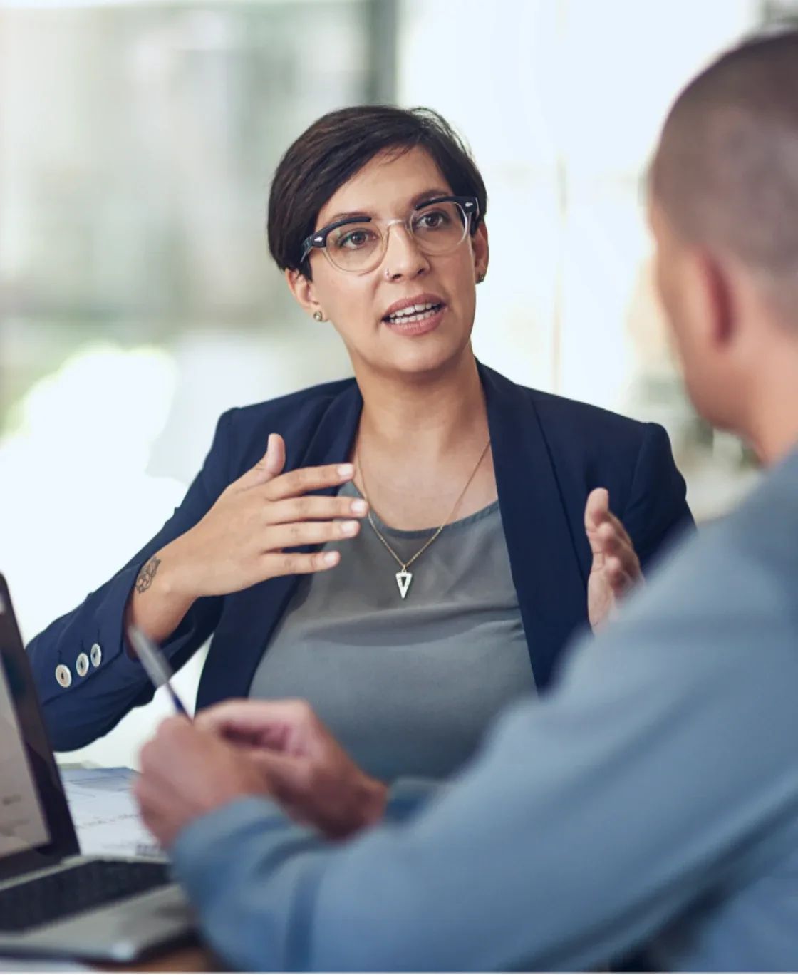 Advisor explaining a plan to a client across a desk