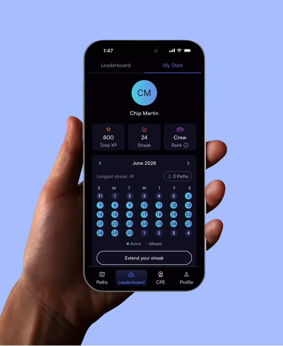 Hand holding a phone with the Paths leaderboard and learning streak calendar