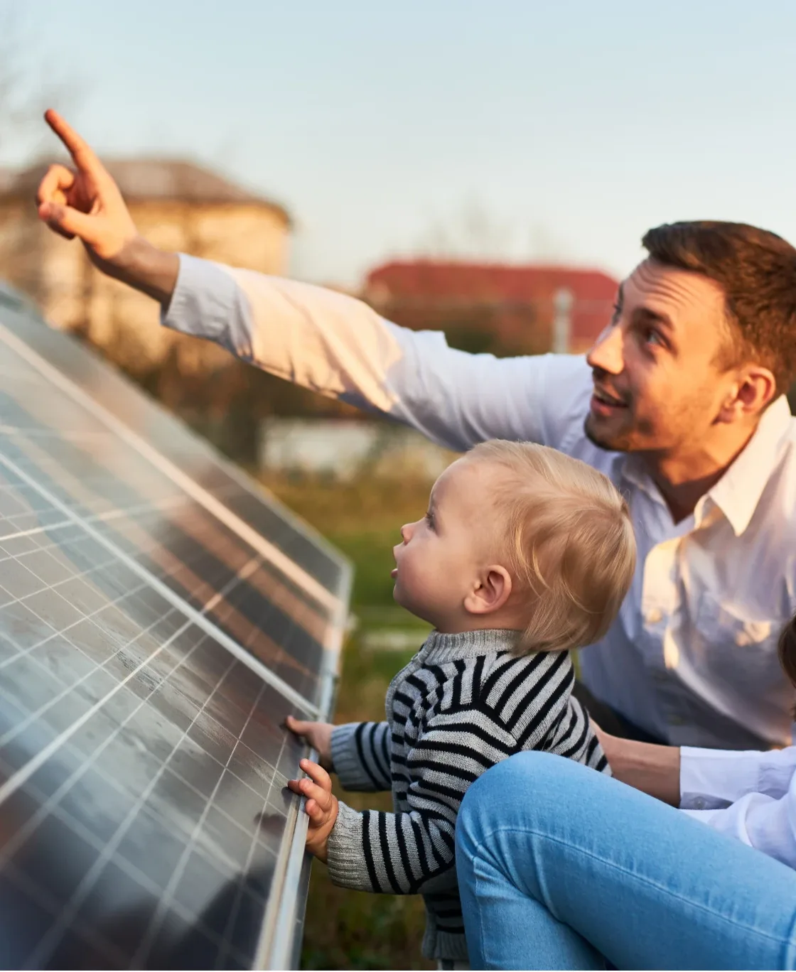 Father and child looking at solar panels outdoors