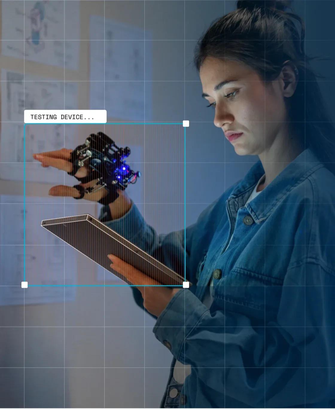 Engineer testing a device held against a tablet with annotation overlays