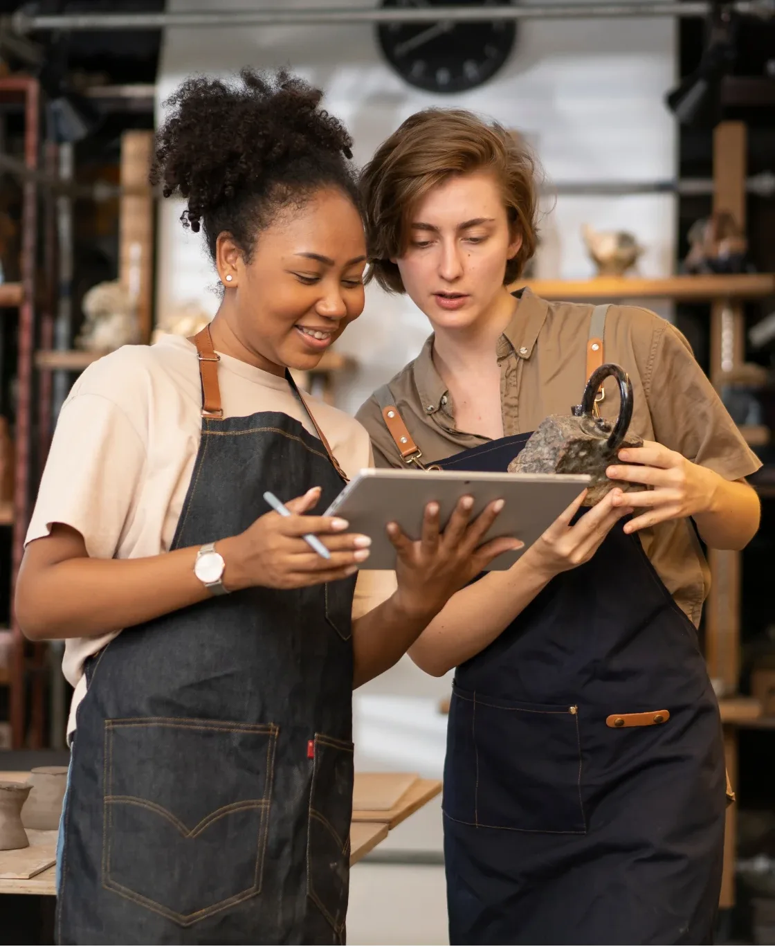 Two shop owners reviewing a tablet together