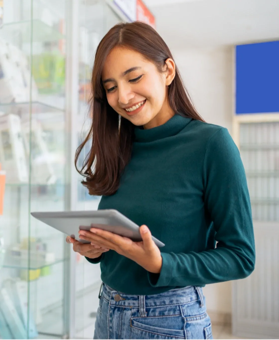 Smiling store employee using a tablet