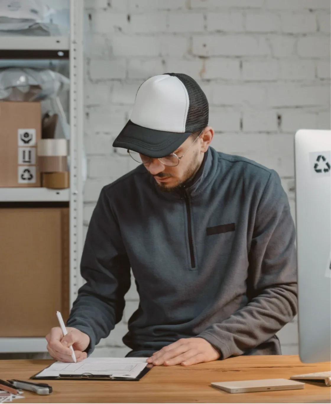 Designer sketching labels at a workbench