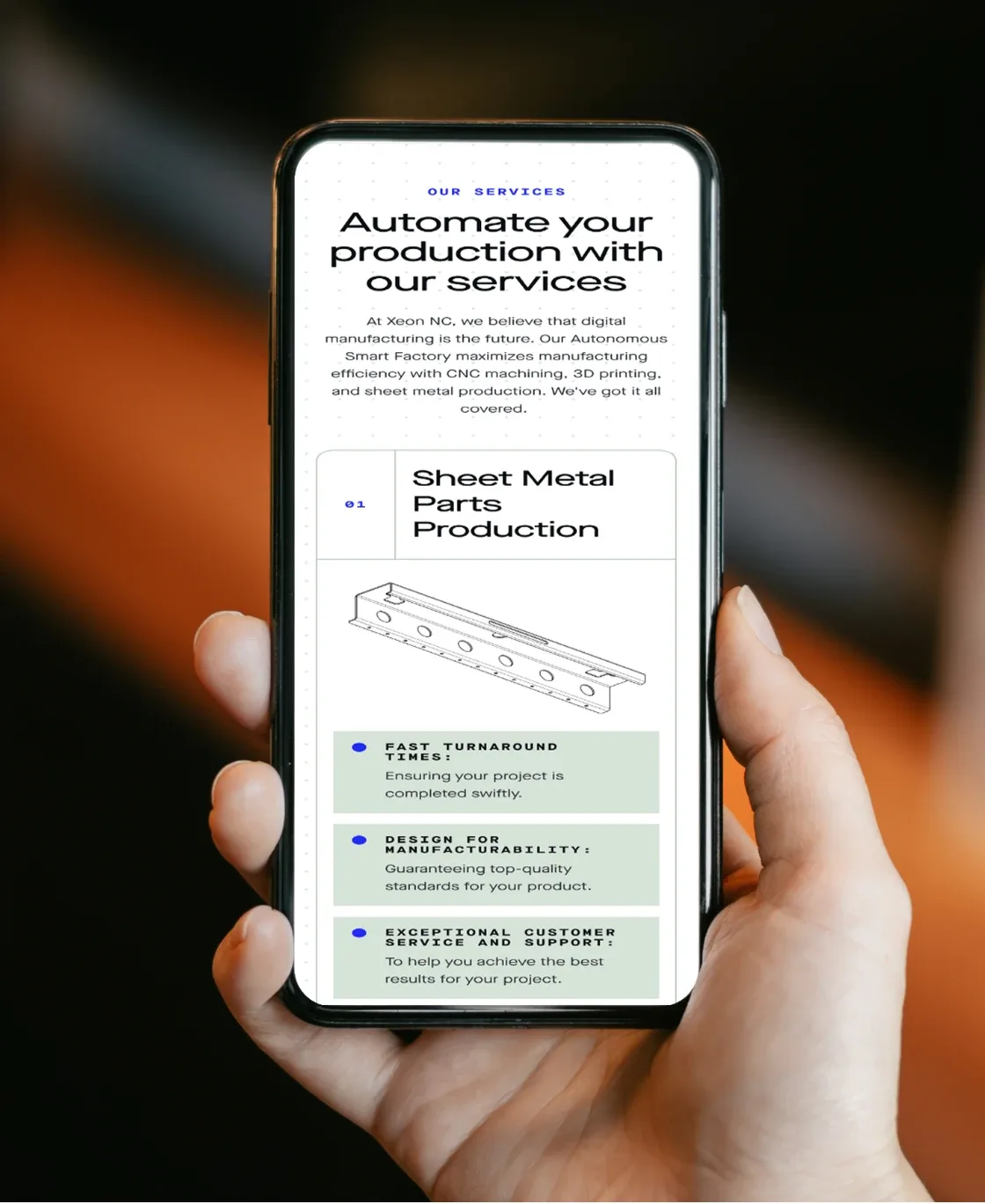 Hand holding a phone with the Xeon NC services page