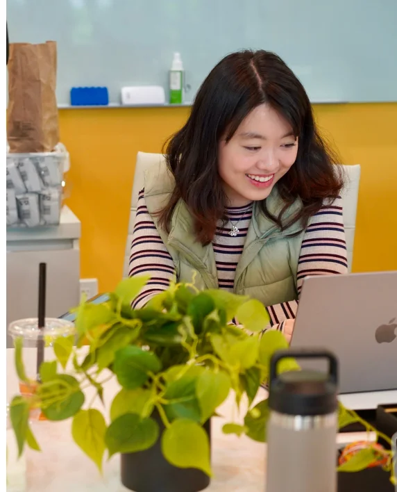 A 500 Designs team member working at her laptop