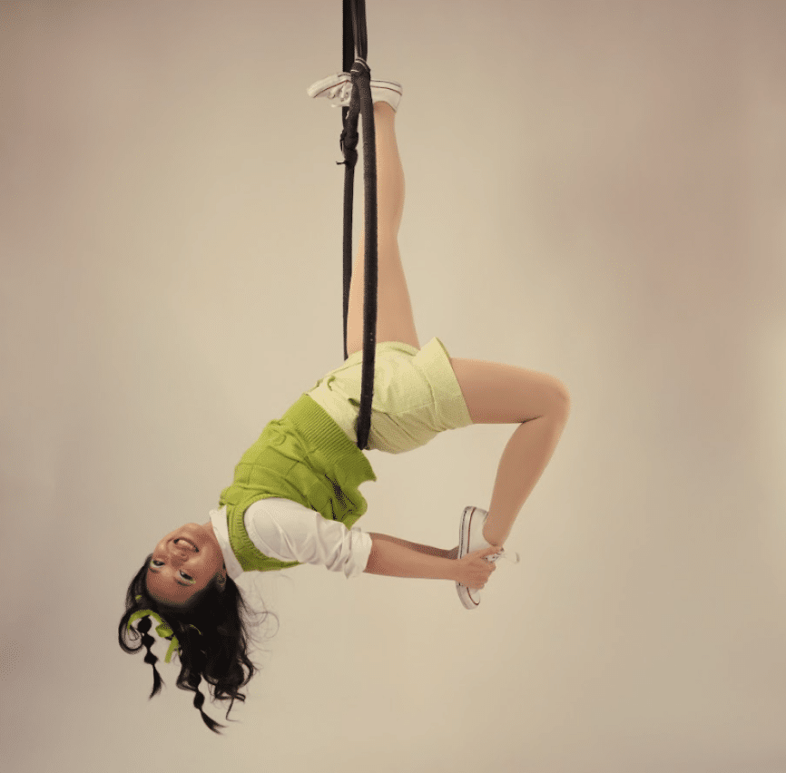 A woman doing upside down acrobatics on the rope