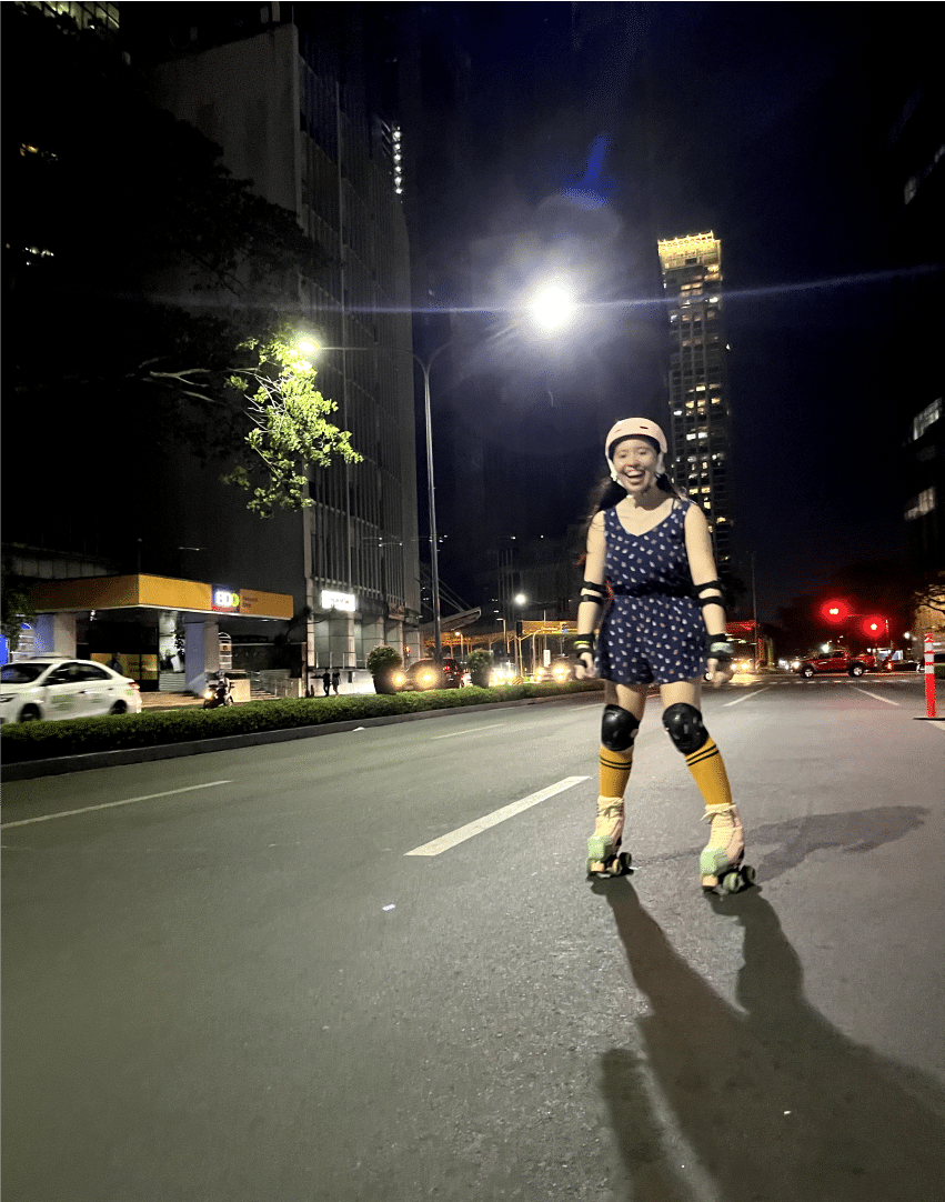 A woman roller skating on the street